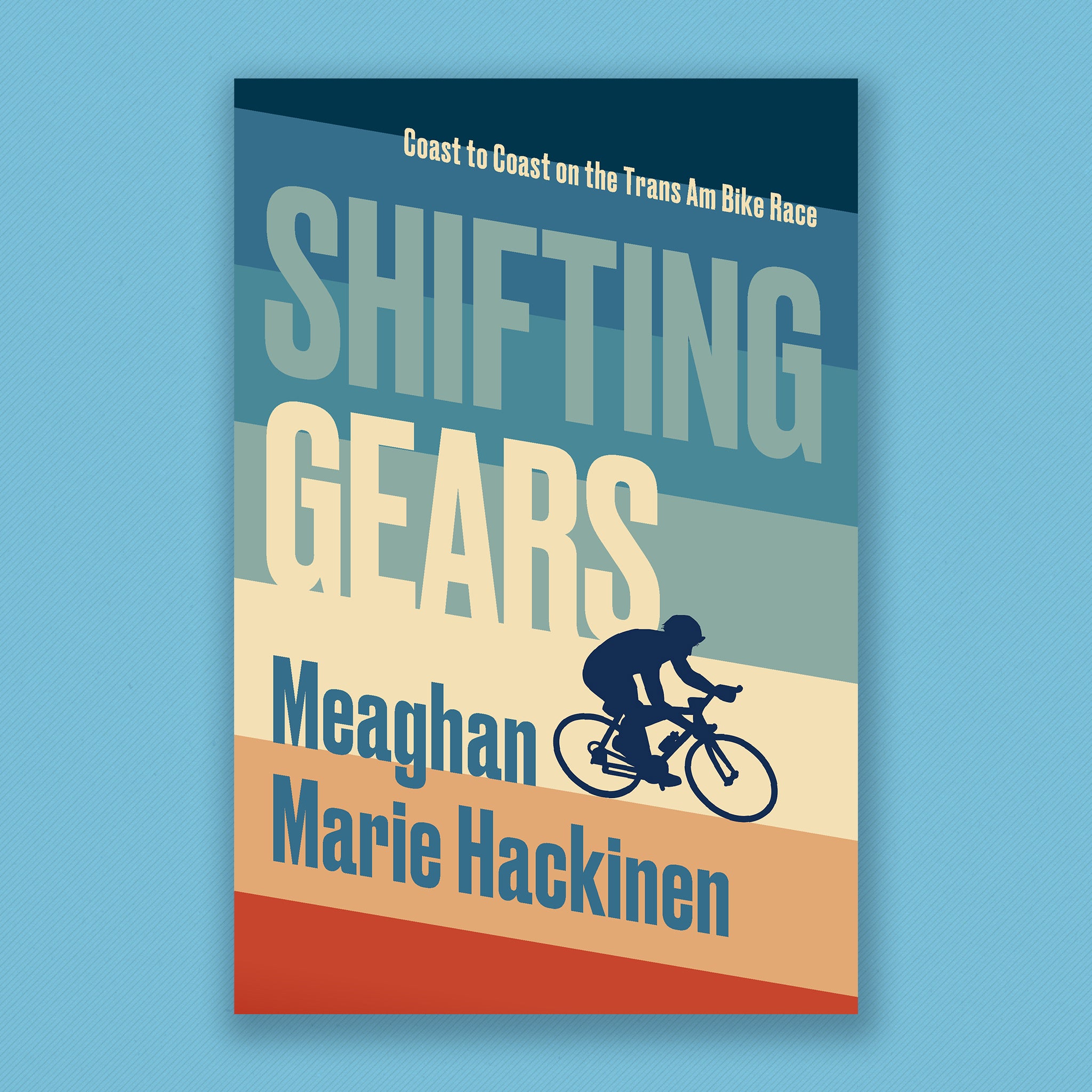 Diagonal vertical stripes move through shades of blue, cream, and finally bright read from top to bottom, with large text following the lines of the stripes and a silhouetted cyclist nestled on the right of cover, cycling off the covers edge. Full text reads: “Shifting Gears: Coast to Coast on the Trans Am Bike Race. Meaghan Marie Hackinen”.