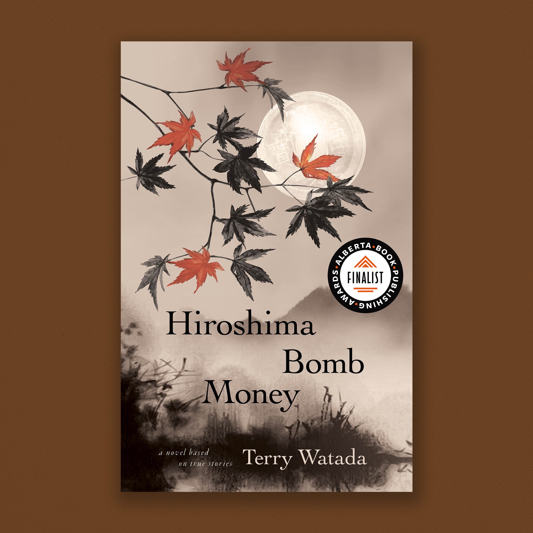 Book Cover: Hiroshima Bomb Money. A novel based on true stories, by Terry Watada. Japanese maple leaves cascade on delicate branches down in front of a mountain scene in the style of a Japanese print. Four of the leaves are red in colour. The rest of the image is greyscale in pallete. 